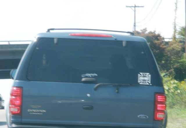 This is blurry a little, so let me narrate.  That cross over on the right side says "Jesus Christ."  That thing in the middle is a decal of a machine gun.  WWJD?